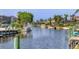 Tranquil waterfront canal with lush greenery, private docks, and waterfront homes evoke a relaxed tropical charm at 4704 Coral Lake Dr, Bradenton, FL 34210