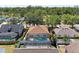 Aerial view of a charming home with a screened pool surrounded by lush greenery and neighboring houses at 4806 69Th E Ct, Palmetto, FL 34221