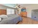 Bedroom with wood-look flooring, ceiling fan, wooden dresser and a gray Winchester gun safe at 4806 69Th E Ct, Palmetto, FL 34221