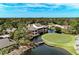 Aerial view of a community featuring a golf course, clubhouse, and beautiful surrounding landscape at 5309 Myrtle Wood Rd # 43, Sarasota, FL 34235