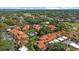 Aerial view of residential community featuring a swimming pool, lush greenery, and tree-lined streets at 5346 Huntingwood Ct # 21, Sarasota, FL 34235