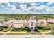 Beautiful image of the community clubhouse entrance featuring lush tropical landscaping at 5816 Helicon Pl, Sarasota, FL 34238