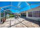 Enclosed patio area with seating, tranquil lake views, and a comfortable outdoor setting at 5816 Helicon Pl, Sarasota, FL 34238