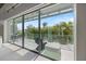 Bright balcony with comfortable seating overlooks lush tropical landscaping at 600 De Narvaez Dr, Longboat Key, FL 34228