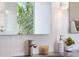 Modern bathroom sink with stylish faucet, decorative marble accents, and a bright vanity light at 600 De Narvaez Dr, Longboat Key, FL 34228