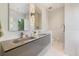 Modern bathroom with double vanity, sleek countertops, decorative lighting, and large mirror at 600 De Narvaez Dr, Longboat Key, FL 34228