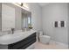 A lovely bathroom boasts a floating vanity, vessel sink, and large frameless mirror at 600 De Narvaez Dr, Longboat Key, FL 34228