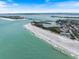 Picturesque aerial view of a pristine public beach with calm, clear water and a bridge in the distance at 600 De Narvaez Dr, Longboat Key, FL 34228