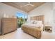 Bright bedroom with vaulted wood ceilings, large window with a green outdoor view, and stylish furniture at 600 De Narvaez Dr, Longboat Key, FL 34228