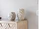 A modern dresser is accented with two decorative carved off-white vases at 600 De Narvaez Dr, Longboat Key, FL 34228