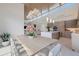 Open concept dining area with wood table, modern decor, and view to the living room and kitchen at 600 De Narvaez Dr, Longboat Key, FL 34228