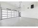 Spacious garage featuring a modern glass door and clean, epoxy-coated flooring, with ample room for vehicles at 600 De Narvaez Dr, Longboat Key, FL 34228