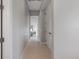 Bright hallway with tile flooring and white trim showing an open view of the main bedroom at 600 De Narvaez Dr, Longboat Key, FL 34228
