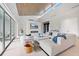 Bright living room with white sectional sofa, high ceilings, fireplace, and modern accents at 600 De Narvaez Dr, Longboat Key, FL 34228