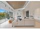 Spacious living room featuring a modern fireplace, a large sectional sofa, and lots of natural light at 600 De Narvaez Dr, Longboat Key, FL 34228
