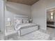 This bedroom is spacious and bright and has a luxurious bed, and the view to the Primary bathroom is visible at 600 De Narvaez Dr, Longboat Key, FL 34228