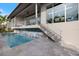 The home's stunning pool has a waterfall feature and relaxing outdoor living space at 600 De Narvaez Dr, Longboat Key, FL 34228