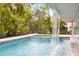 The serene backyard pool includes a tranquil waterfall and plenty of space to relax at 600 De Narvaez Dr, Longboat Key, FL 34228