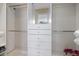 Bright walk-in closet with built-in organizers, drawers, shelving, and custom storage solutions at 600 De Narvaez Dr, Longboat Key, FL 34228