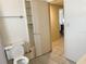 Bathroom featuring an open cabinet, tiled floors, and doorway to an adjacent room at 6408 2Nd W Ave, Bradenton, FL 34209