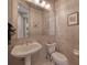 Chic powder room featuring elegant fixtures and textured wallpaper at 6605 Waters Edge Way, Lakewood Ranch, FL 34202