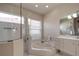 Bright bathroom with a soaking tub, walk-in shower and tiled floor and walls at 6605 Waters Edge Way, Lakewood Ranch, FL 34202