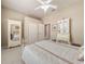 Bedroom with a ceiling fan, white iron bed frame, and white painted furniture at 6605 Waters Edge Way, Lakewood Ranch, FL 34202