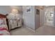 Cozy bedroom featuring a mirrored dresser, neutral walls, and a view into a bathroom at 6605 Waters Edge Way, Lakewood Ranch, FL 34202