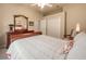 Bedroom with a carved wood sleigh bed, neutral-toned walls, and an ensuite bathroom at 6605 Waters Edge Way, Lakewood Ranch, FL 34202