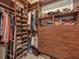 Organized walk-in closet with custom wood shelving, drawers, and ample storage space at 6605 Waters Edge Way, Lakewood Ranch, FL 34202