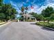 View of the secure community gate with manicured landscaping and an American flag waving in the breeze at 6605 Waters Edge Way, Lakewood Ranch, FL 34202