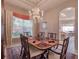 Spacious dining room with a chandelier and large window offering natural light at 6605 Waters Edge Way, Lakewood Ranch, FL 34202