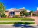Well-maintained home with manicured lawn, brick driveway, and tropical landscaping on a sunny day at 6605 Waters Edge Way, Lakewood Ranch, FL 34202