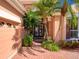 Home featuring a landscaped entrance with brick driveway, glass front doors, and mature palms at 6605 Waters Edge Way, Lakewood Ranch, FL 34202