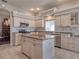 This kitchen has an island with granite countertops and stainless steel appliances at 6605 Waters Edge Way, Lakewood Ranch, FL 34202
