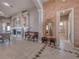 Open living room with tiled floors, fireplace, high ceilings, columns, and decorative accents at 6605 Waters Edge Way, Lakewood Ranch, FL 34202