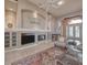 Comfortable living room with a fireplace, built-in shelving, and views to the front entry at 6605 Waters Edge Way, Lakewood Ranch, FL 34202