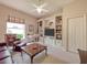 Bright living room featuring custom built-in shelving and a comfortable seating area at 6605 Waters Edge Way, Lakewood Ranch, FL 34202