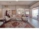 Spacious living room with elegant furnishings, tile flooring, and arched openings to other rooms at 6605 Waters Edge Way, Lakewood Ranch, FL 34202