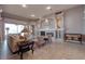 Spacious living room offering tile floors, a fireplace, and views of the screened patio at 6605 Waters Edge Way, Lakewood Ranch, FL 34202