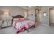 Comfortable main bedroom featuring a mirrored nightstand and upholstered bench at 6605 Waters Edge Way, Lakewood Ranch, FL 34202
