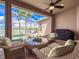 Covered patio with waterfront views featuring outdoor seating and a barbecue grill at 6605 Waters Edge Way, Lakewood Ranch, FL 34202
