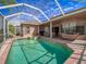 Relaxing pool area with screened-in patio, outdoor furniture, and serene water views offer a tranquil backyard retreat at 6605 Waters Edge Way, Lakewood Ranch, FL 34202