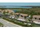 Aerial view showcasing the condo buildings, lush landscaping and water views at 6611 Grand Estuary Trl # 105, Bradenton, FL 34212