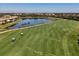 Aerial view of the golf course, golf carts and housing. Lush green landscaping surrounds a lake at 6611 Grand Estuary Trl # 105, Bradenton, FL 34212