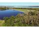 Breathtaking aerial view of the community with a lake, golf course, and lush greenery, ideal for outdoor recreation at 6611 Grand Estuary Trl # 105, Bradenton, FL 34212