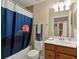 Bathroom showcasing vanity with a lighthouse-themed shower curtain at 6611 Grand Estuary Trl # 105, Bradenton, FL 34212
