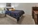 Bedroom with a blue patterned bedspread and vintage furniture at 6611 Grand Estuary Trl # 105, Bradenton, FL 34212