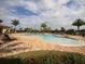Enjoy relaxing in the community pool with a brick patio and clear blue sky at 6611 Grand Estuary Trl # 105, Bradenton, FL 34212