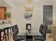 Dining area with table and chairs next to a half-wall to the kitchen and a vertical blinds feature at 6611 Grand Estuary Trl # 105, Bradenton, FL 34212